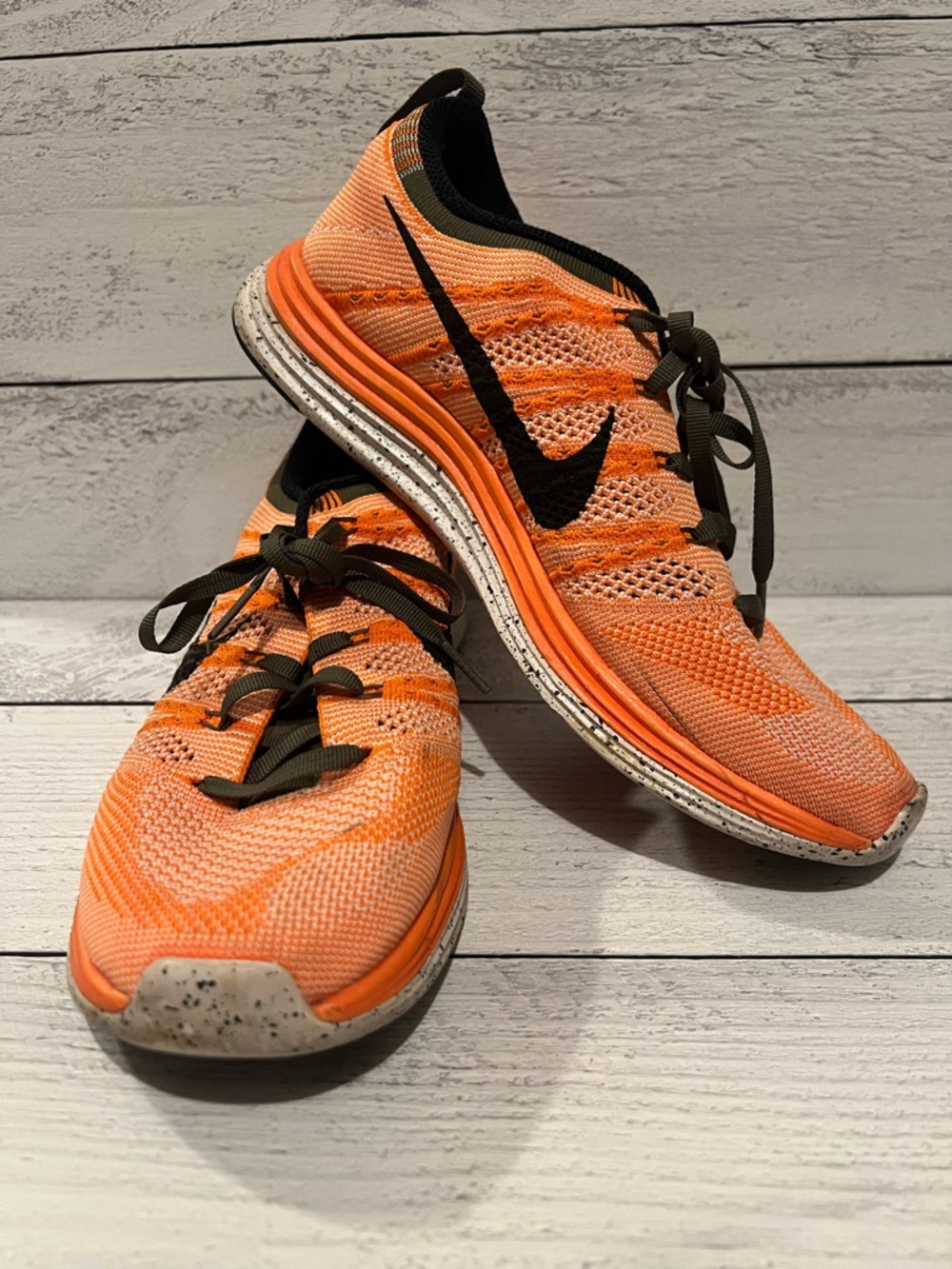 Nike Women’s Orange and Black Flyknit Running Shoes